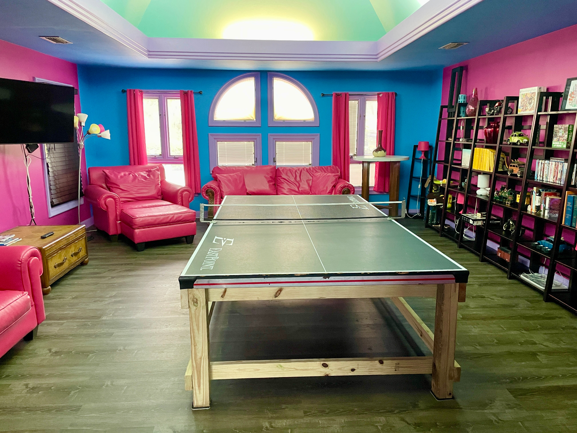 Game room with ping pong table and colorful seating